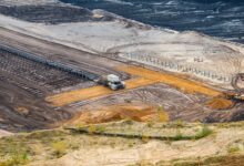 Aerial view of an open-pit mining operation showing excavation and processing equipment