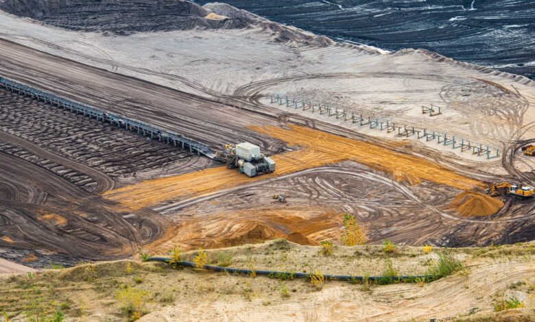 Aerial view of an open-pit mining operation showing excavation and processing equipment