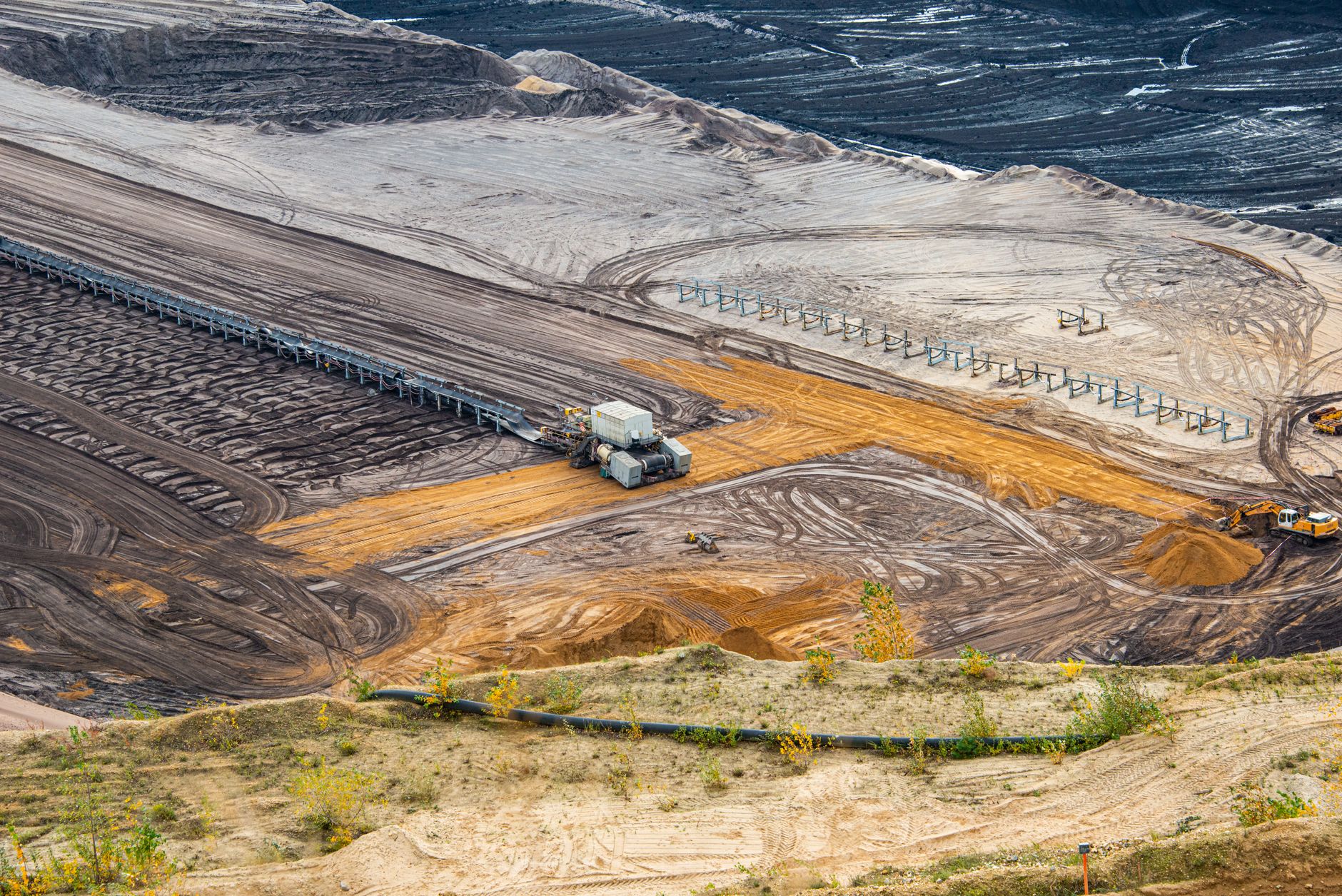 Aerial view of an open-pit mining operation showing excavation and processing equipment