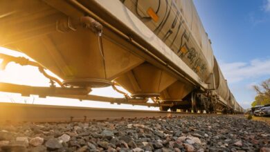 A freight train moving through a rural rail corridor representing easement land rights