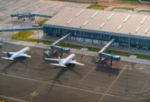 Aerial view of airport tarmac with aircraft parked at gates