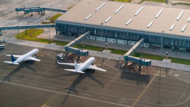 Aerial view of airport tarmac with aircraft parked at gates
