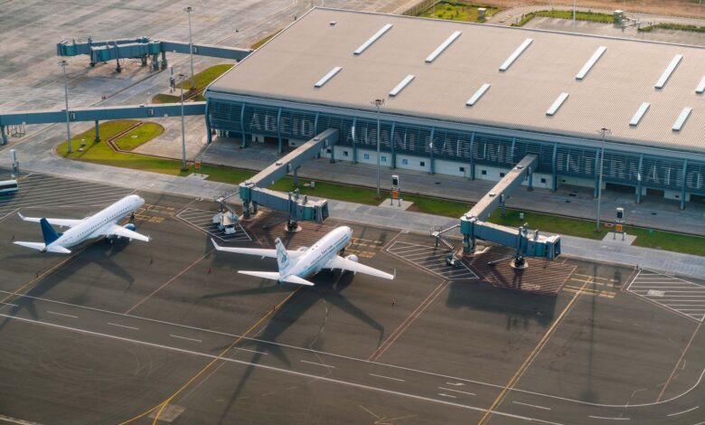 Aerial view of airport tarmac with aircraft parked at gates