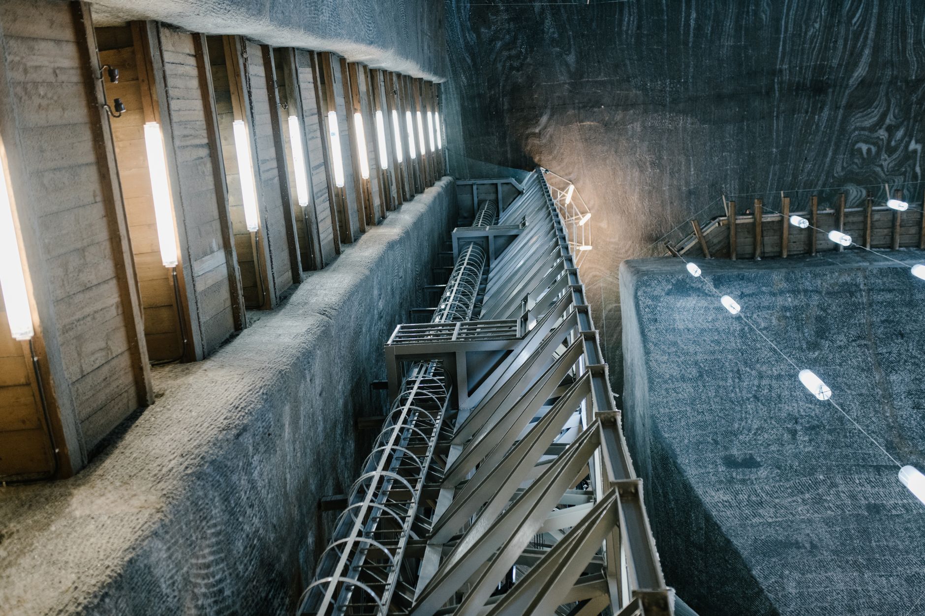 Open pit uranium mine with industrial equipment and exposed rock layers