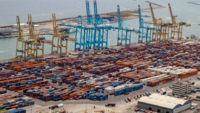 Aerial view of a large container seaport with multiple berths and cargo ships