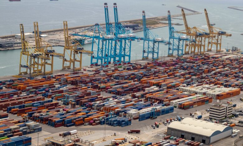 Aerial view of a large container seaport with multiple berths and cargo ships