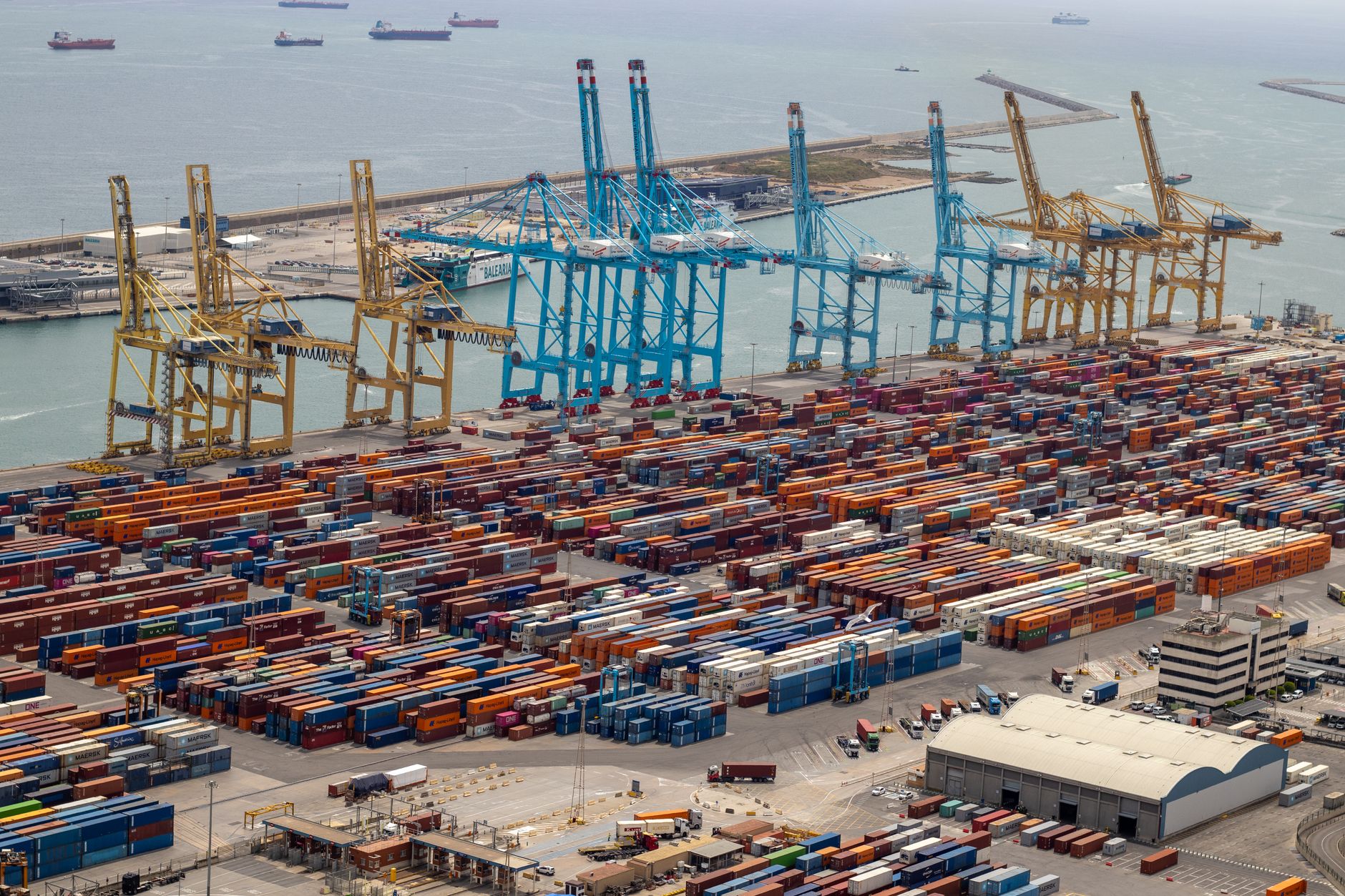Aerial view of a large container seaport with multiple berths and cargo ships