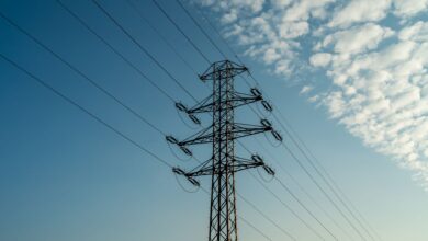 Aerial view of high-voltage electricity transmission lines crossing open land