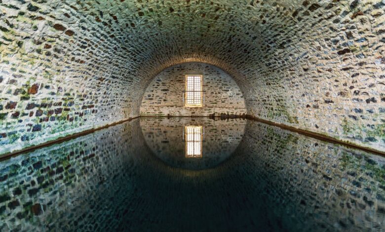 Underground aquifer cross-section diagram illustrating water storage below surface land