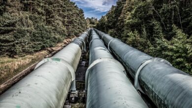 Industrial pipeline under construction across open land representing CO2 transport infrastructure