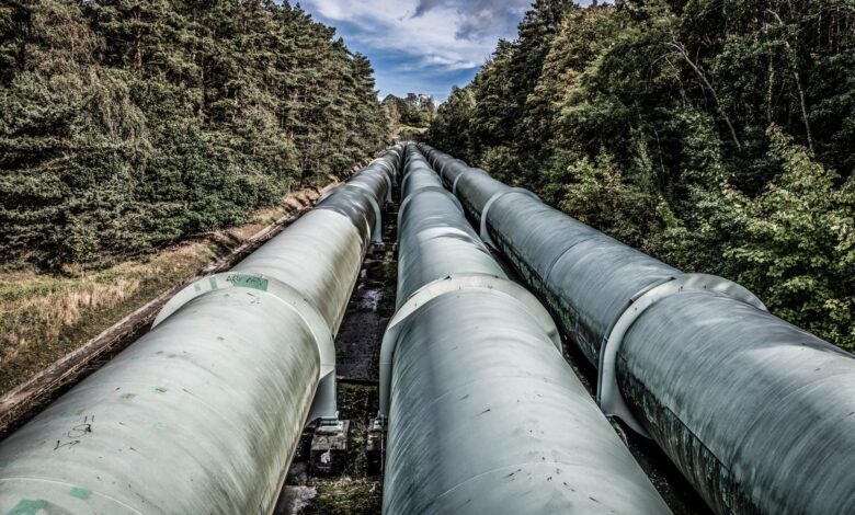 Industrial pipeline under construction across open land representing CO2 transport infrastructure