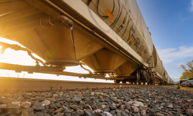 A freight train moving through a rural rail corridor representing easement land rights
