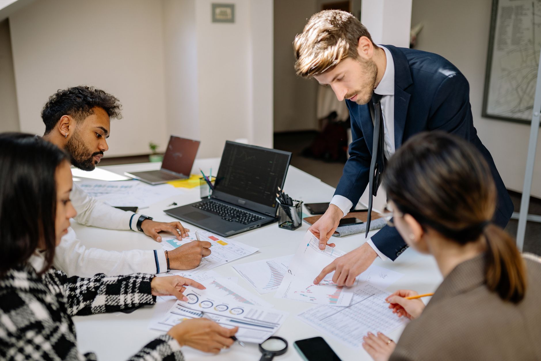 Business professionals reviewing investment documents at a conference table