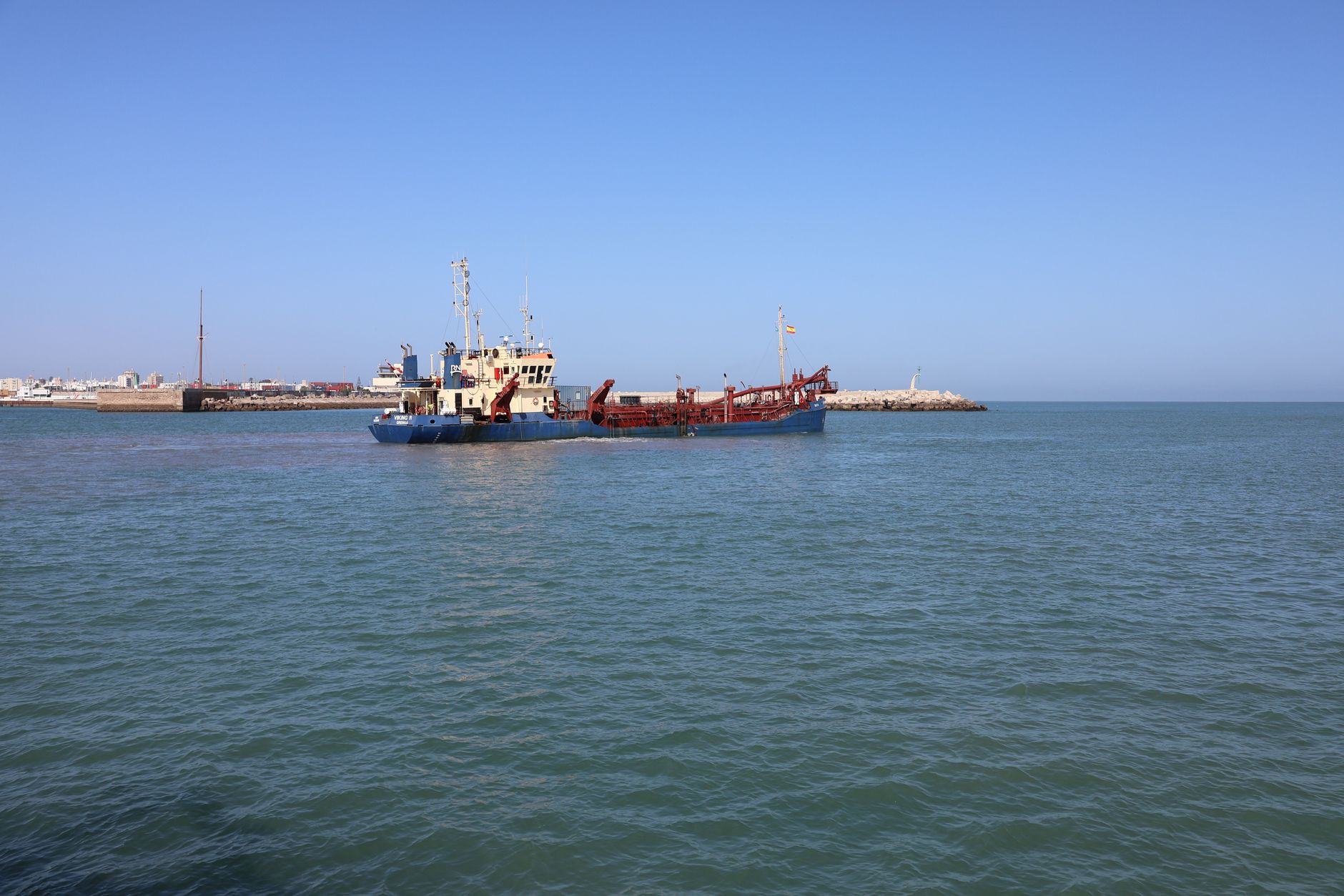 Industrial dredging vessel operating in a deep water shipping channel