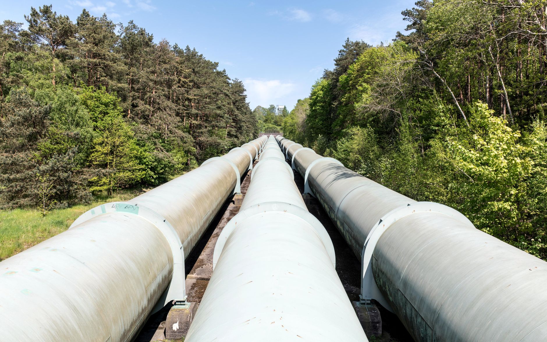 Industrial natural gas pipeline infrastructure in an open field