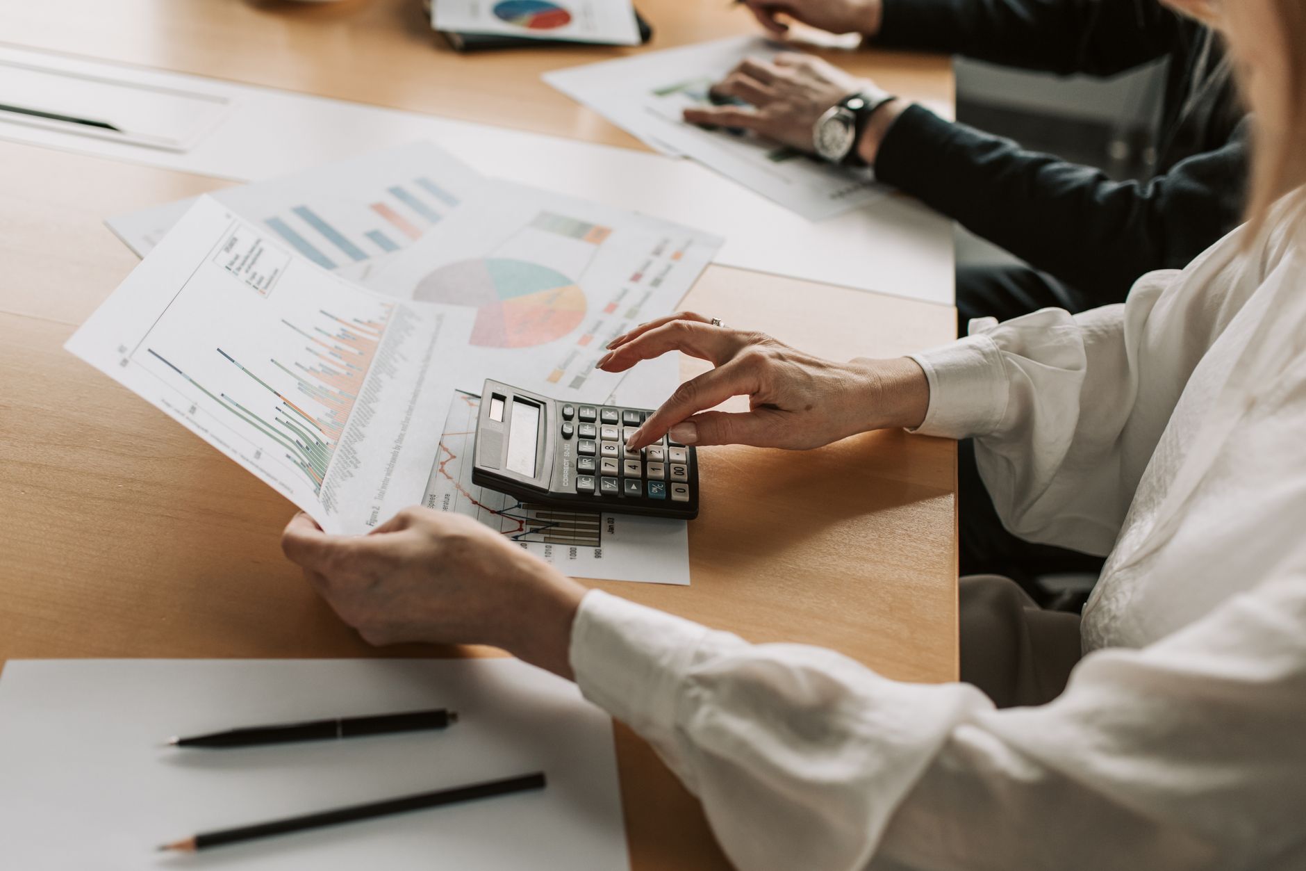 Institutional investors in a boardroom reviewing infrastructure investment portfolios