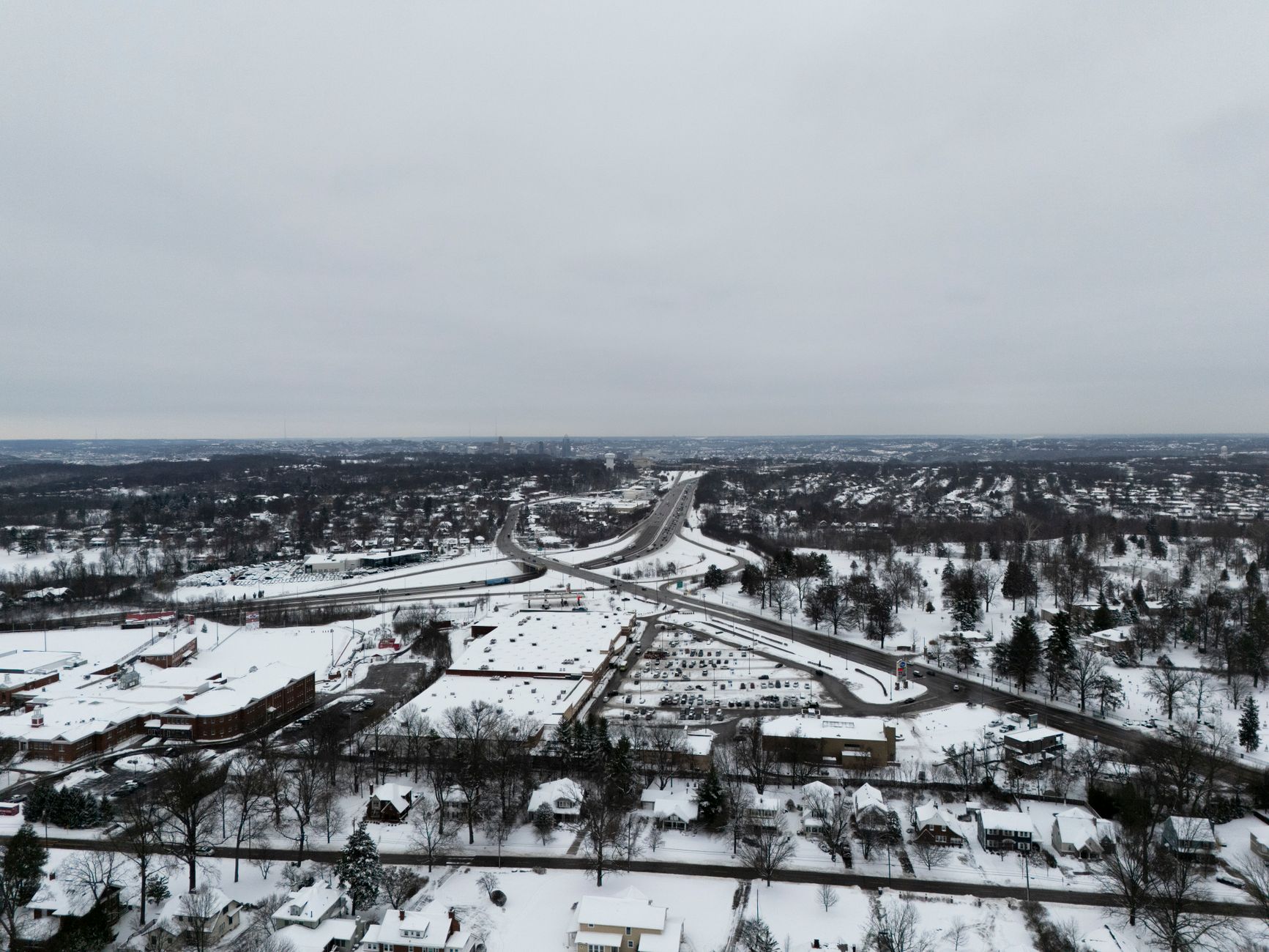 Aerial view of rail and utility infrastructure corridor crossing a landscape