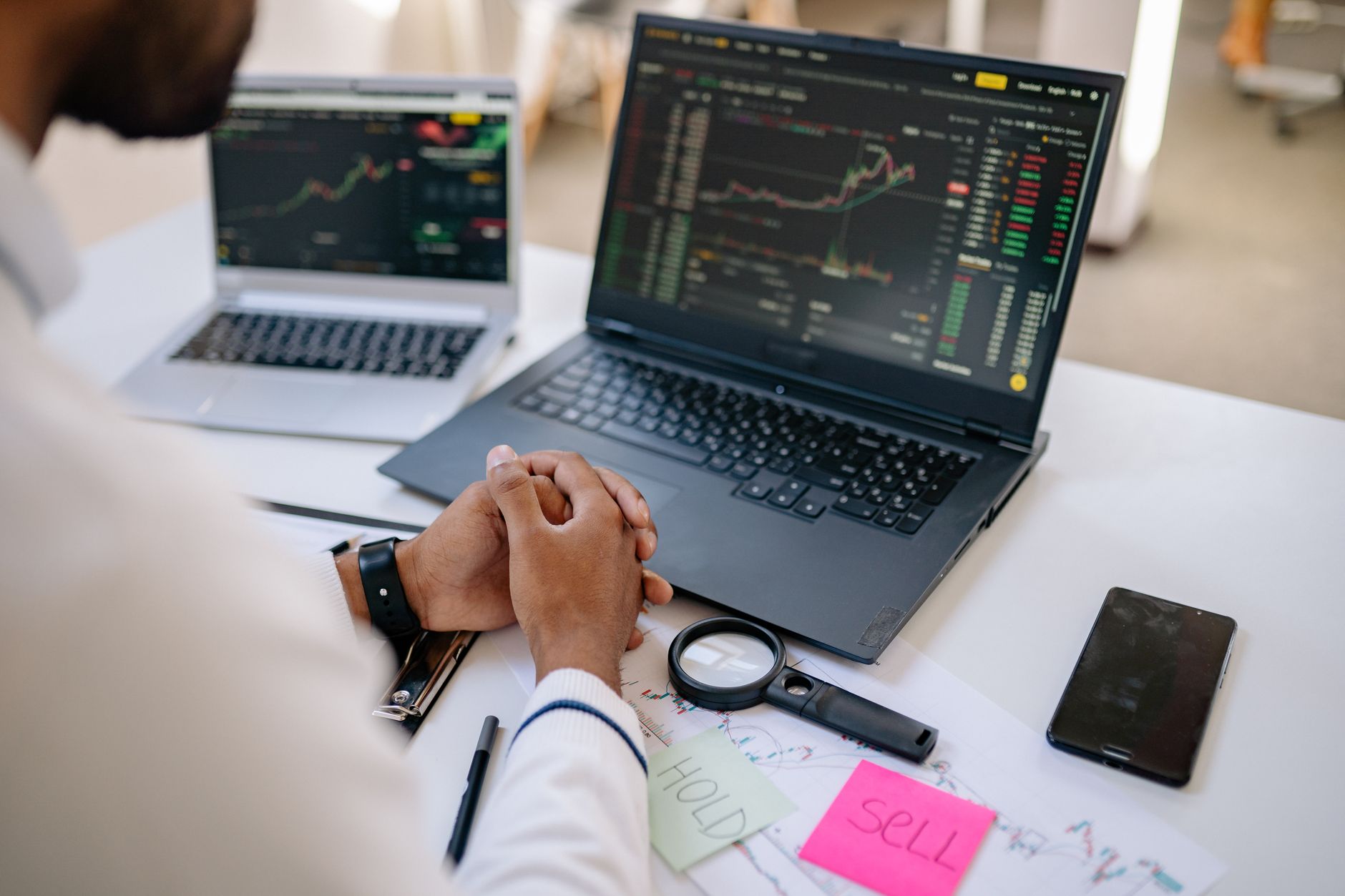Traders monitoring commodity markets on multiple screens at a financial trading desk