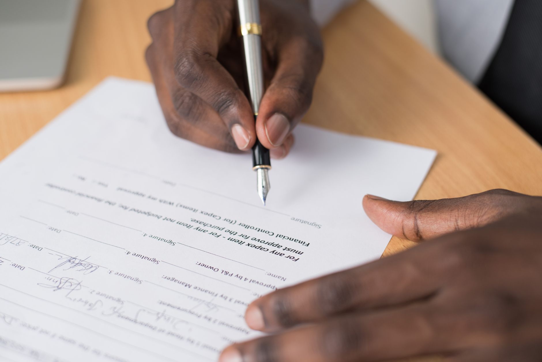 Business professionals reviewing and signing a lease agreement at a conference table