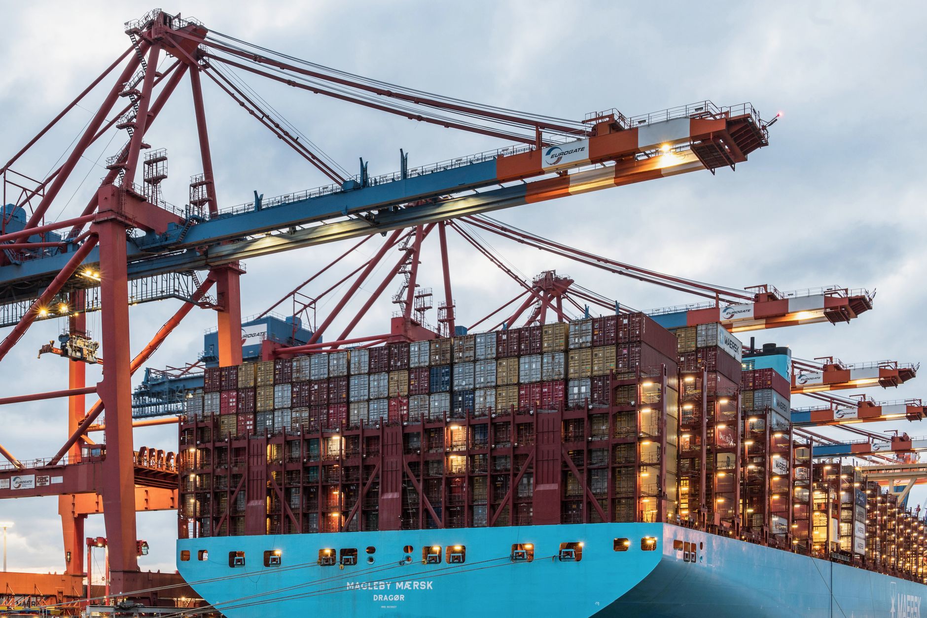 Rows of stacked shipping containers at a busy terminal facility