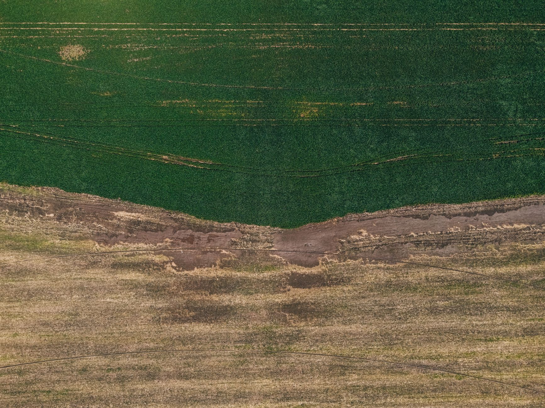 Aerial view of dry agricultural land in an arid region showing water scarcity