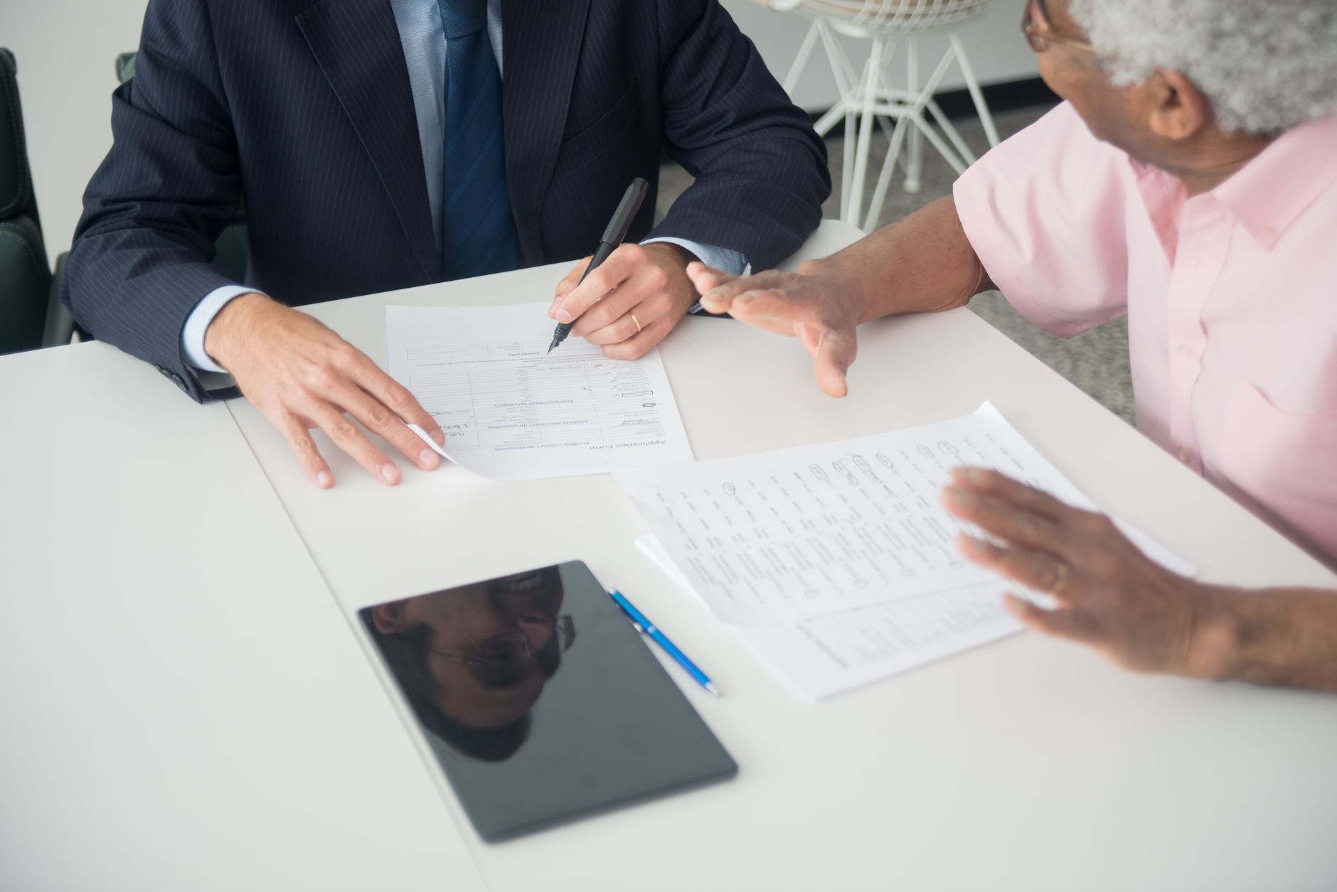 Institutional investors reviewing infrastructure portfolio documents at a boardroom table