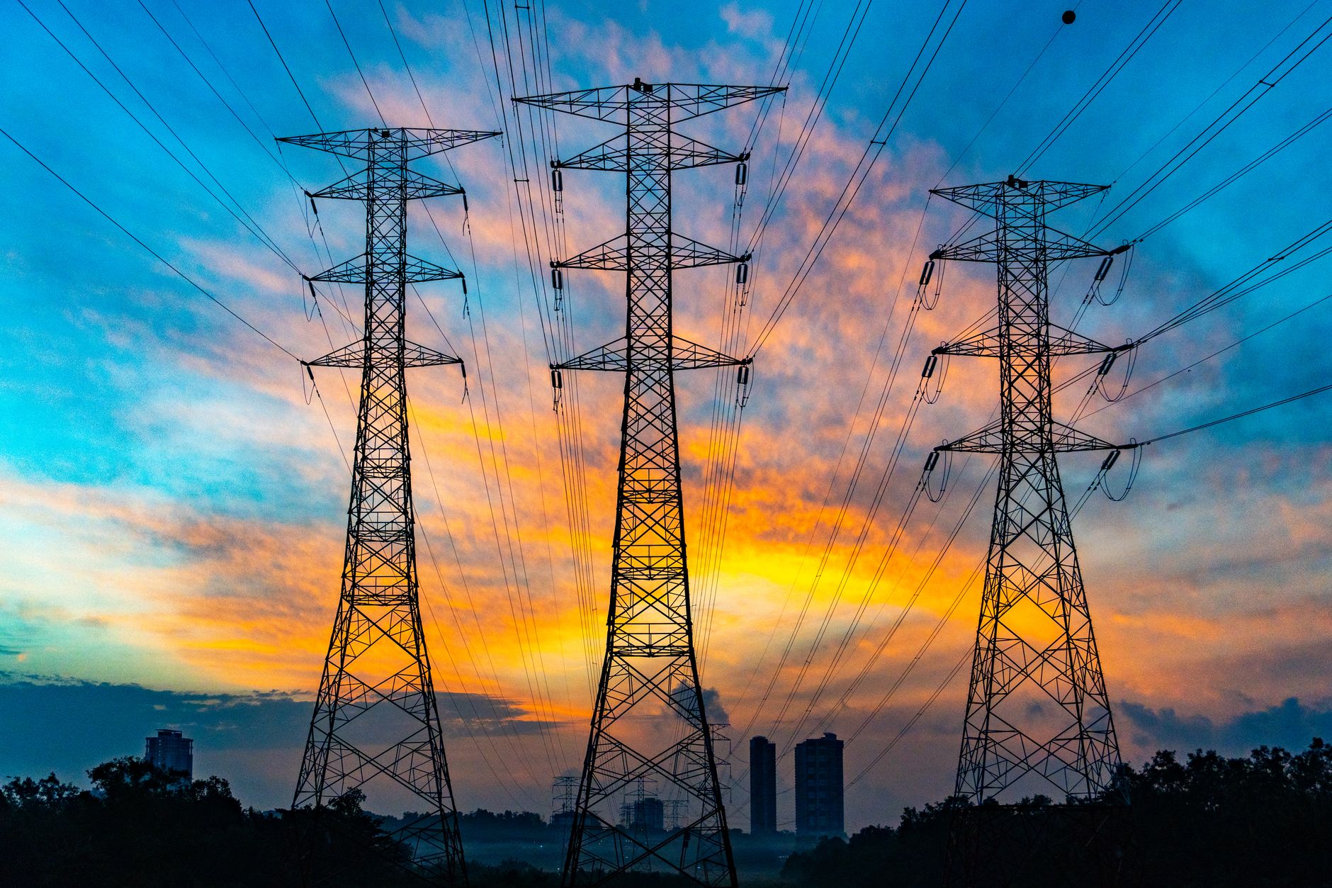 Aerial view of energy infrastructure and transmission lines crossing rural landscape