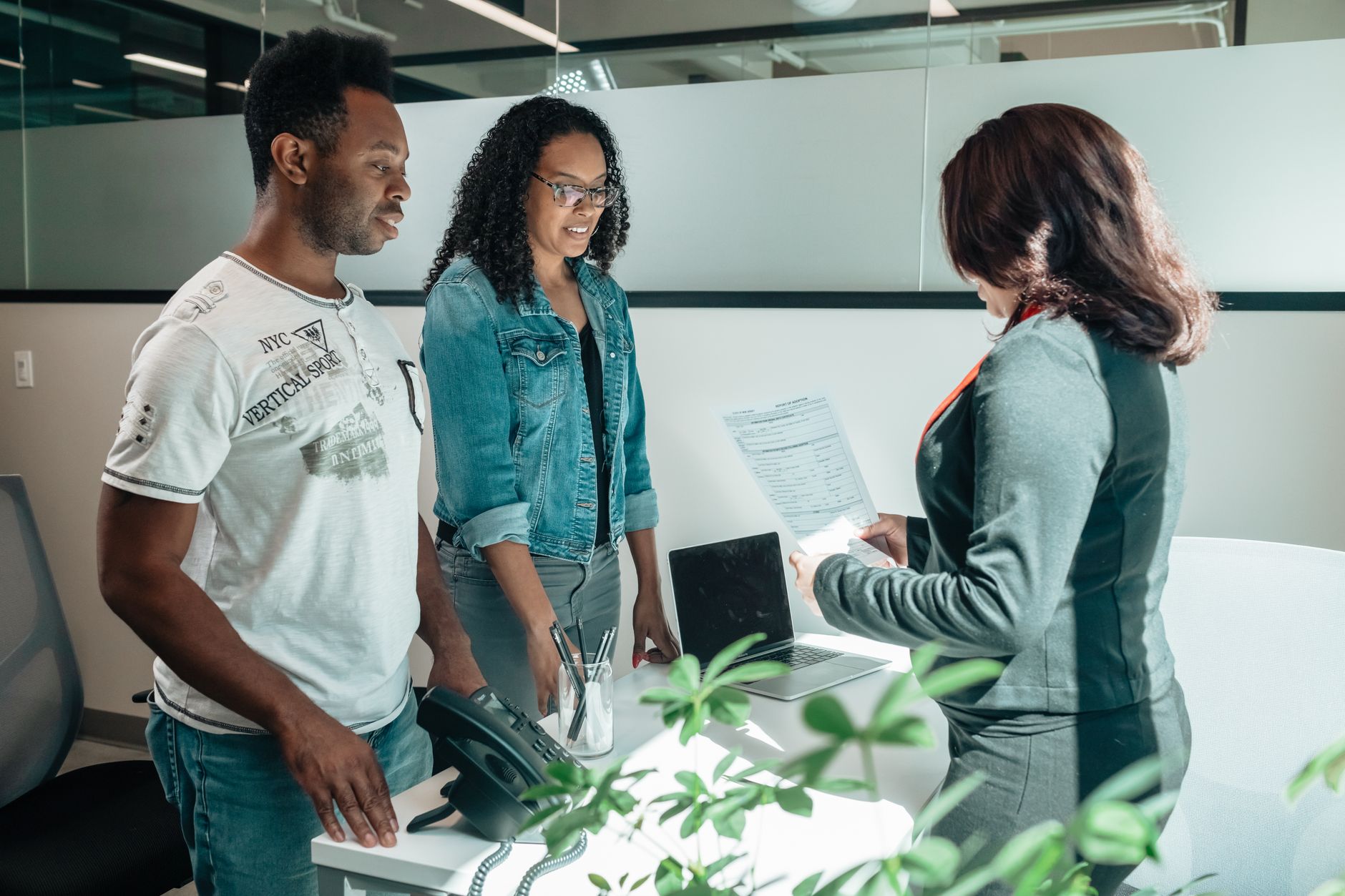 Professionals reviewing investment documents in a private wealth management setting