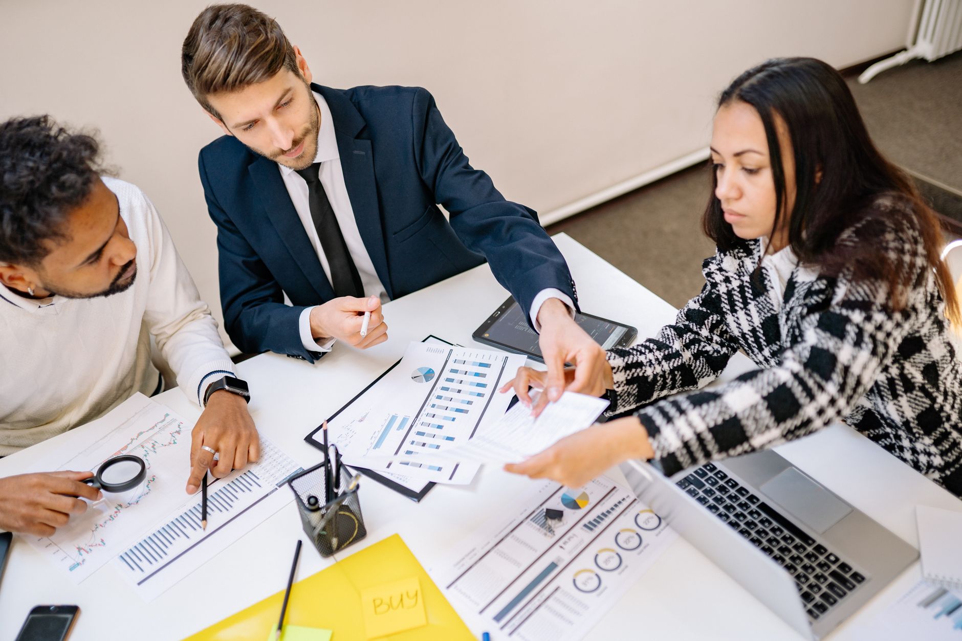 Professionals reviewing investment documents in a private office setting