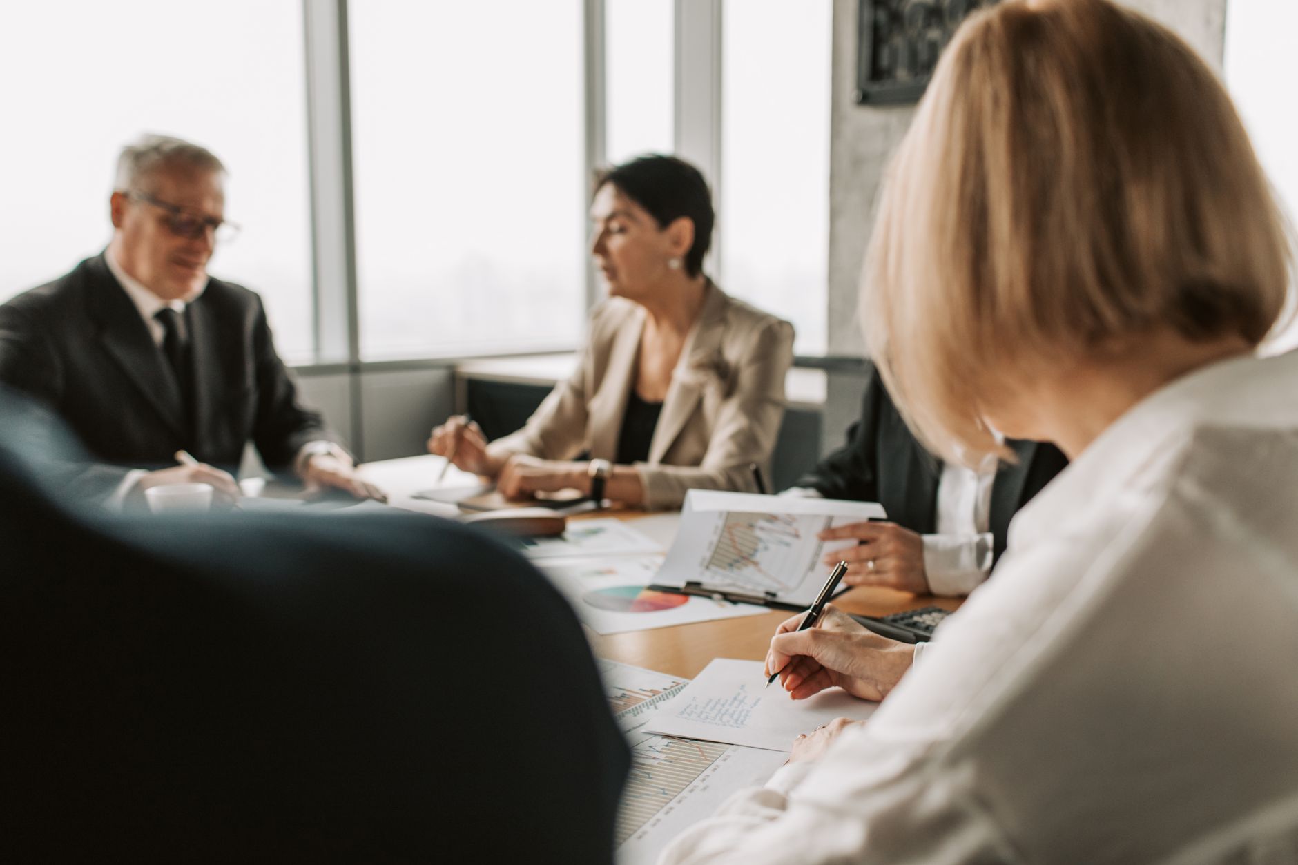 Institutional investors reviewing infrastructure investment documents in a boardroom setting