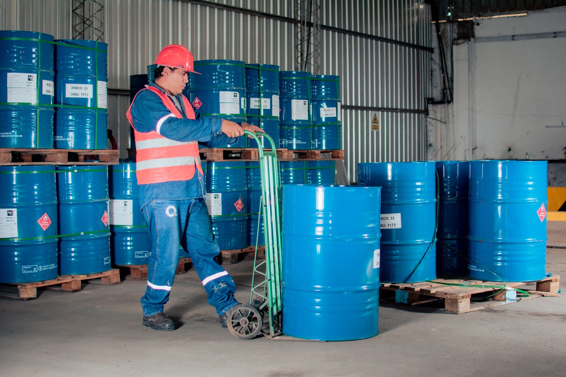 Rows of industrial crude oil storage barrels at an energy facility