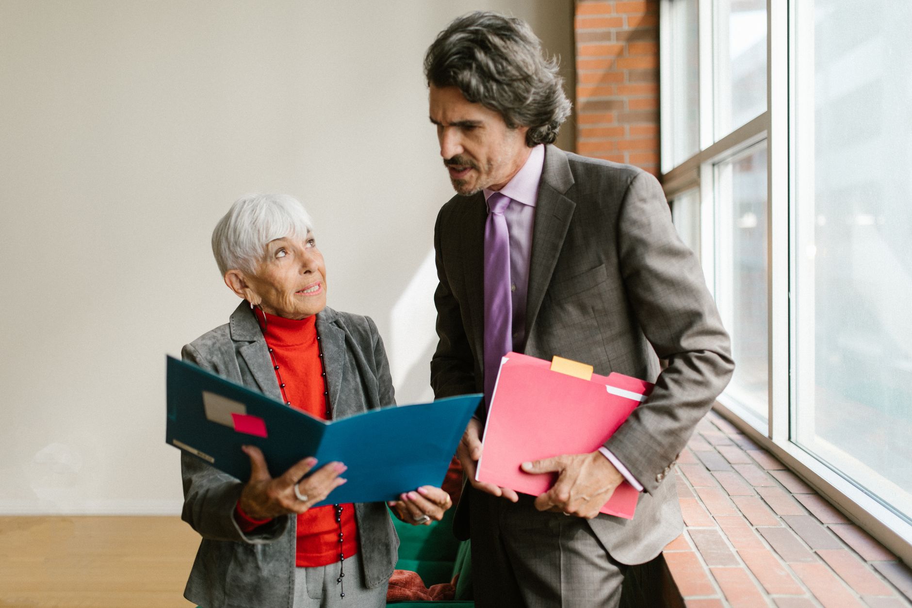 Institutional investors reviewing portfolio documents at a conference table