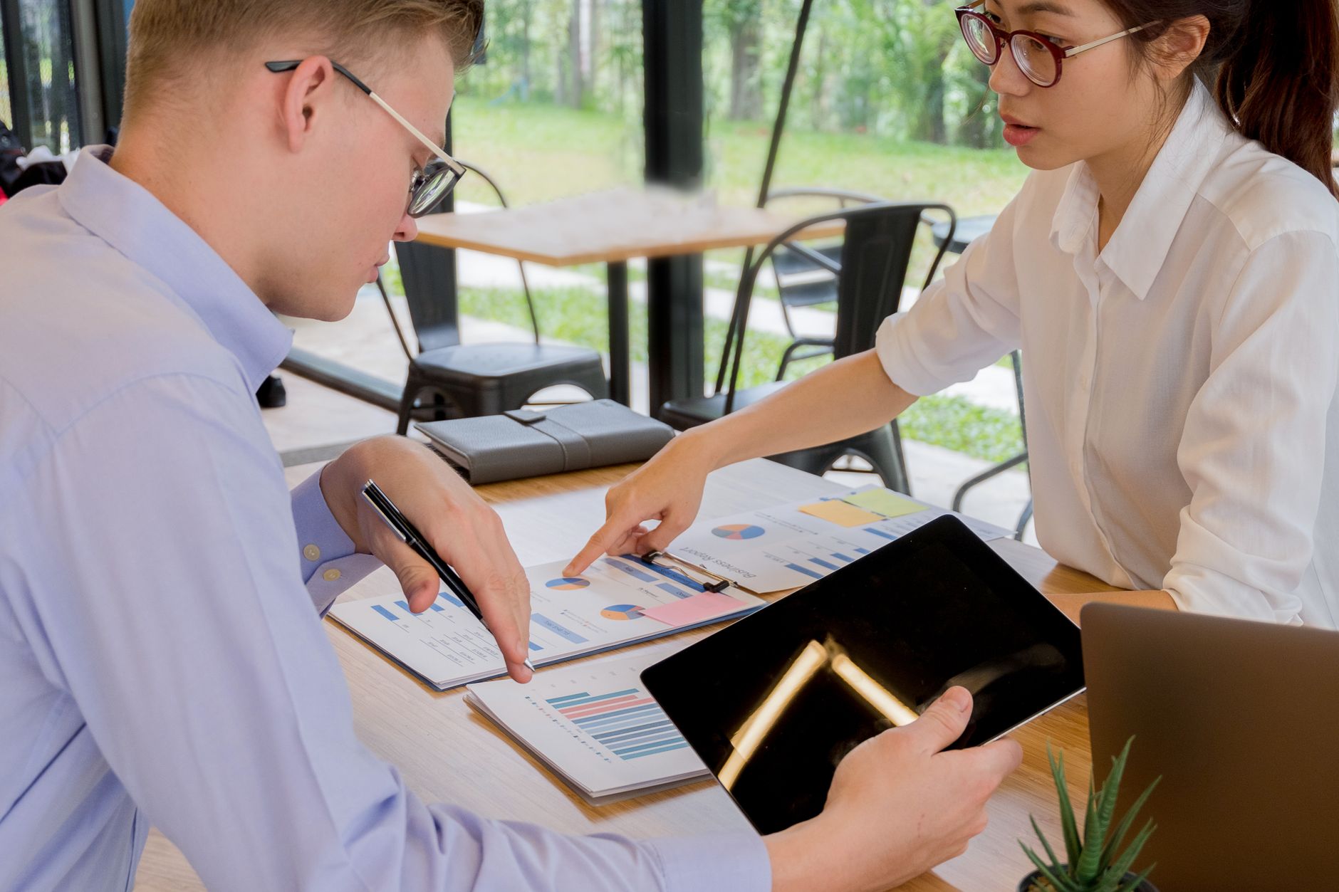Institutional investors reviewing documents at a conference table