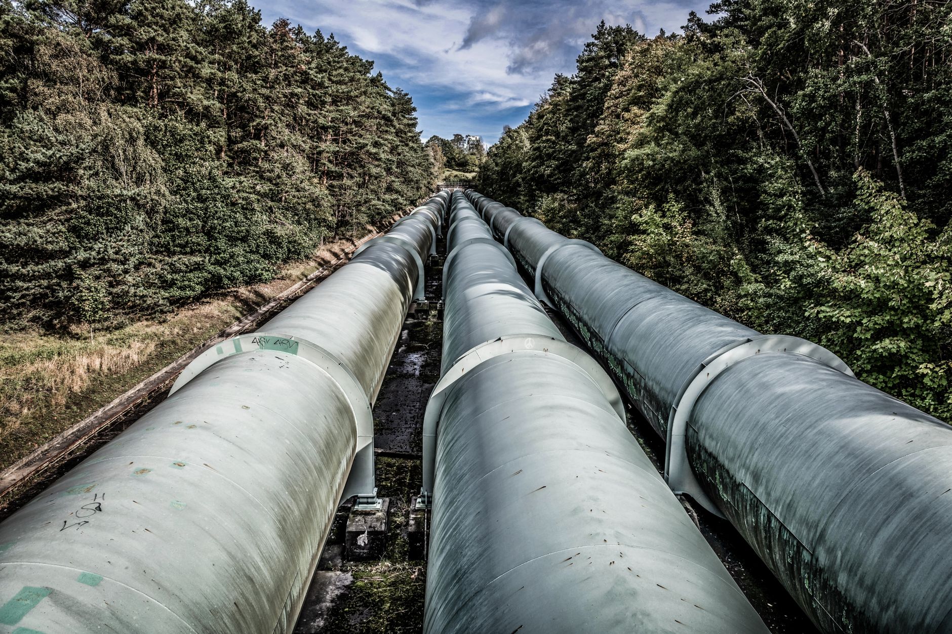 Industrial water pipeline and storage infrastructure in a rural landscape