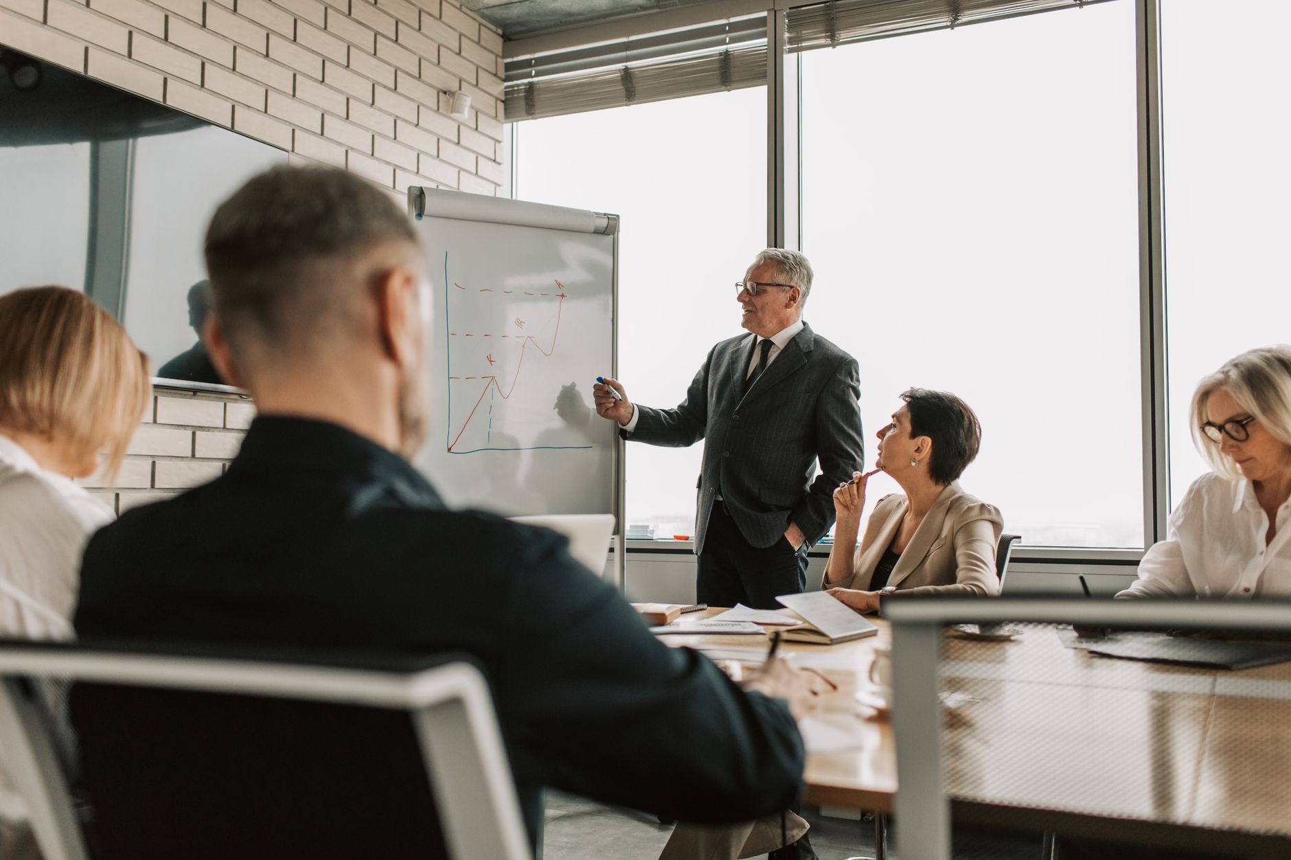 Executives in a boardroom discussing sovereign investment strategy and infrastructure assets