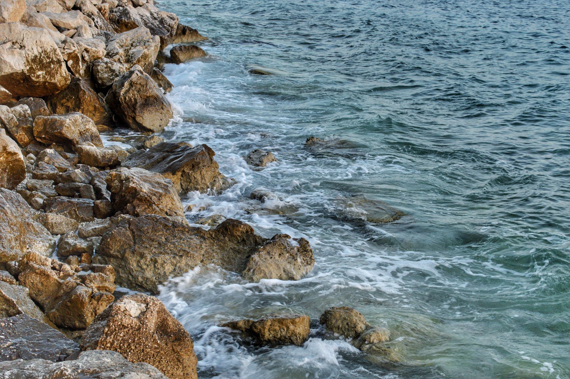 Rocky coastline where submarine cables make landfall connecting to terrestrial networks