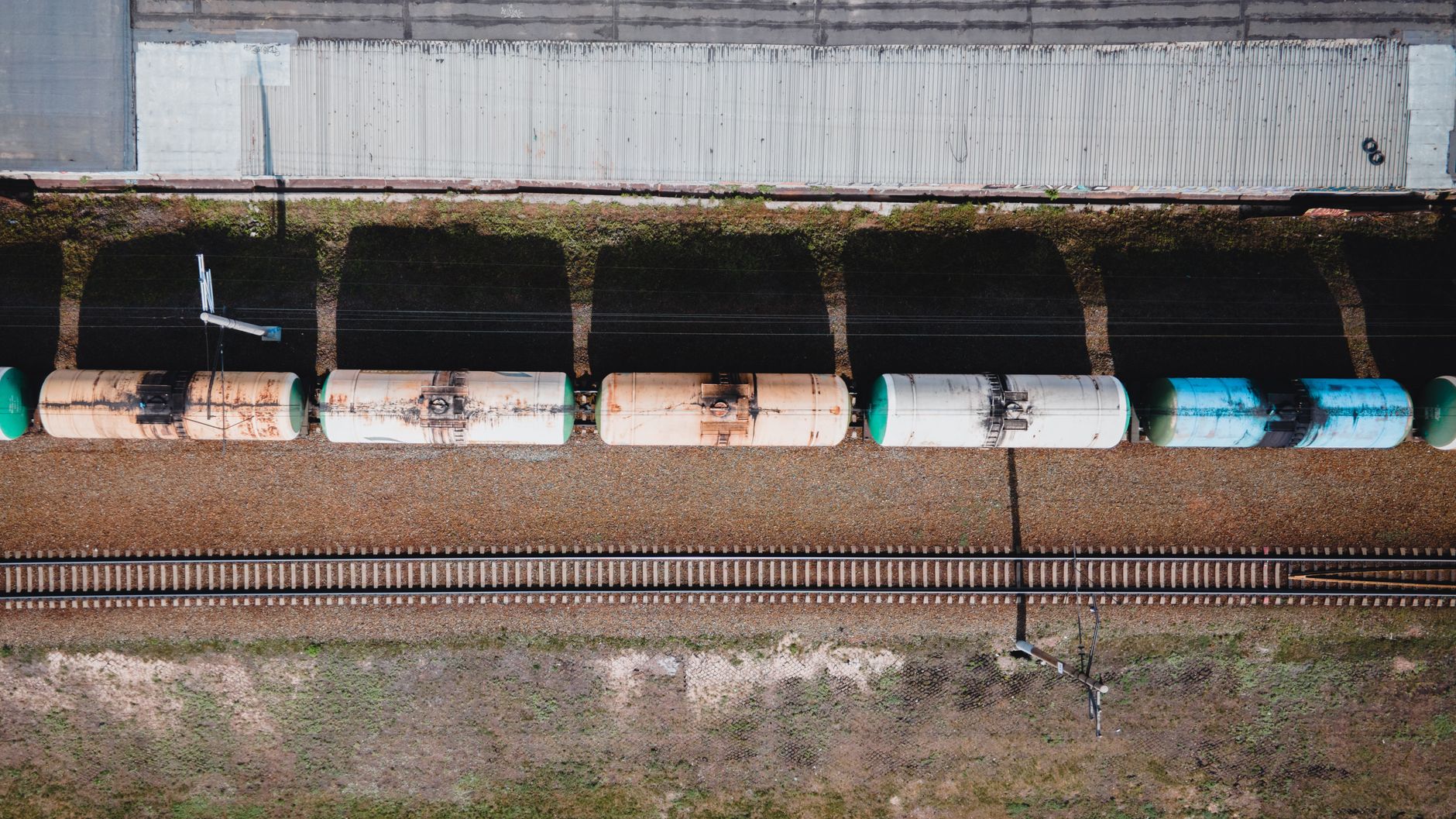 Aerial view of freight rail infrastructure passing through mixed-use land showing easement corridor value