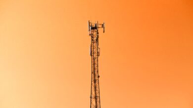 Wireless cell tower rising above open land representing ground lease infrastructure