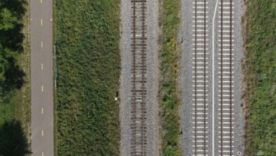 Aerial view of railroad tracks crossing through open countryside