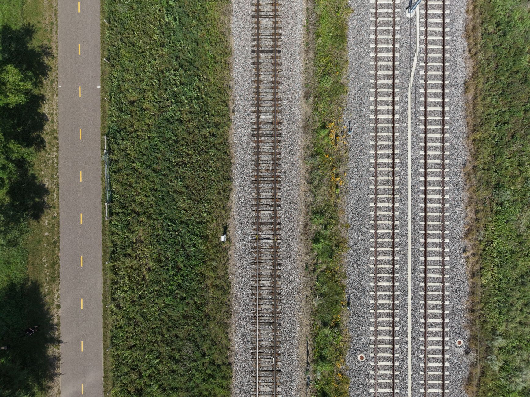 Aerial view of railroad tracks crossing through open countryside