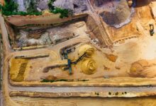 Aerial view of an open gravel quarry pit with extraction equipment
