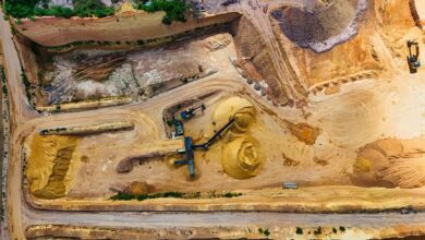 Aerial view of an open gravel quarry pit with extraction equipment