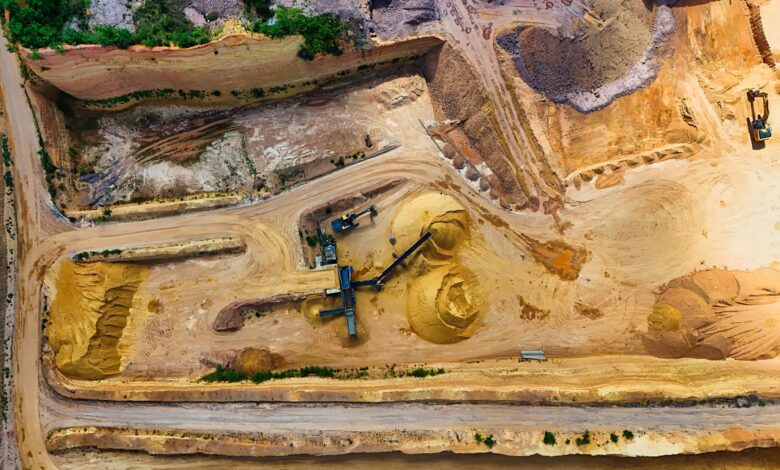 Aerial view of an open gravel quarry pit with extraction equipment