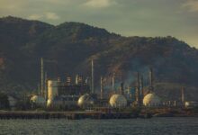 Large industrial oil refinery with processing towers and pipeline infrastructure