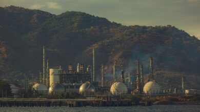 Large industrial oil refinery with processing towers and pipeline infrastructure
