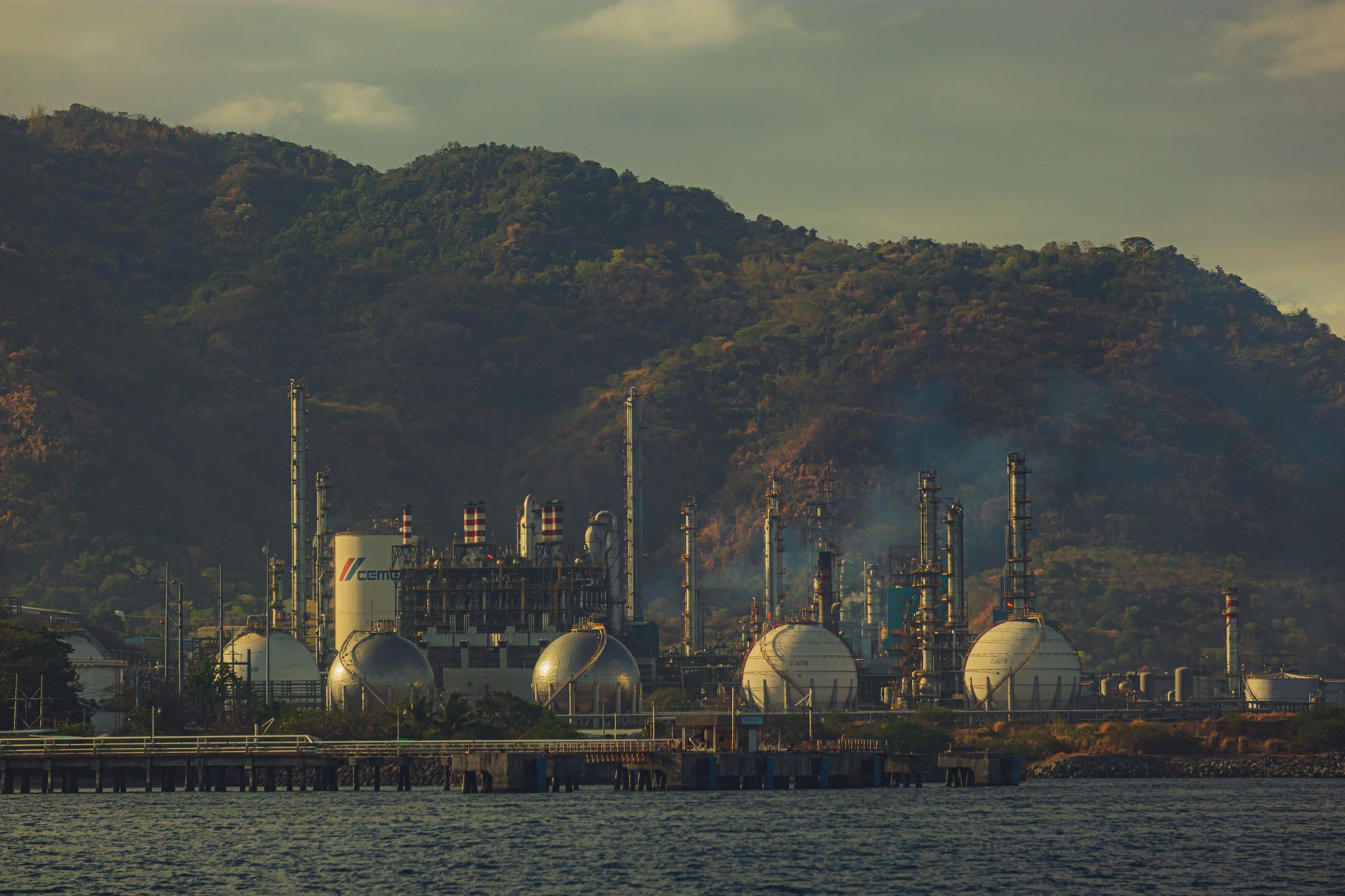 Large industrial oil refinery with processing towers and pipeline infrastructure