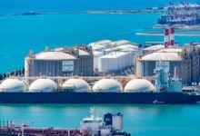 Large LNG tanker vessel docked at an industrial port terminal