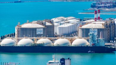 Large LNG tanker vessel docked at an industrial port terminal