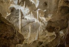 Interior view of a large underground industrial storage facility carved into rock