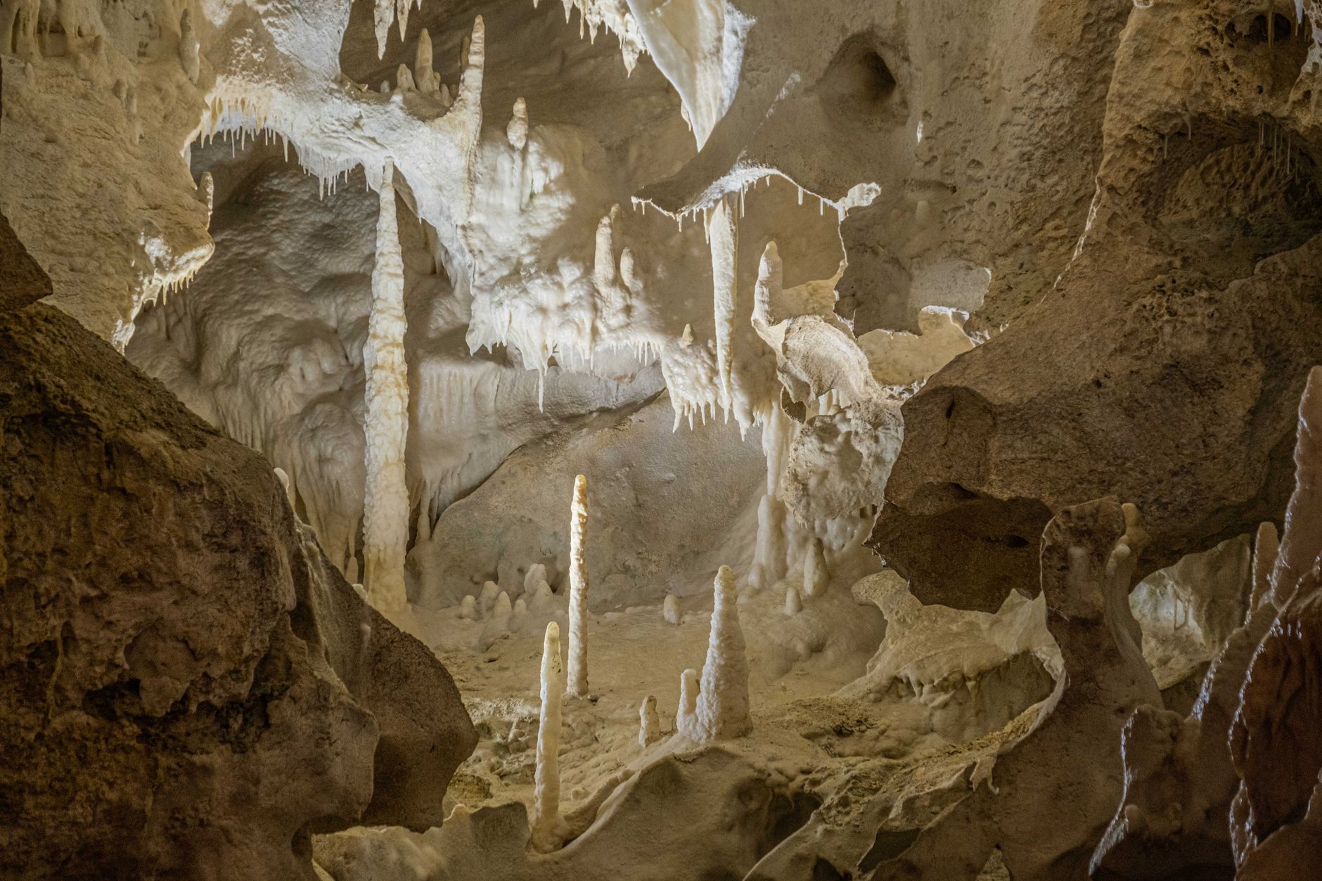 Interior view of a large underground industrial storage facility carved into rock